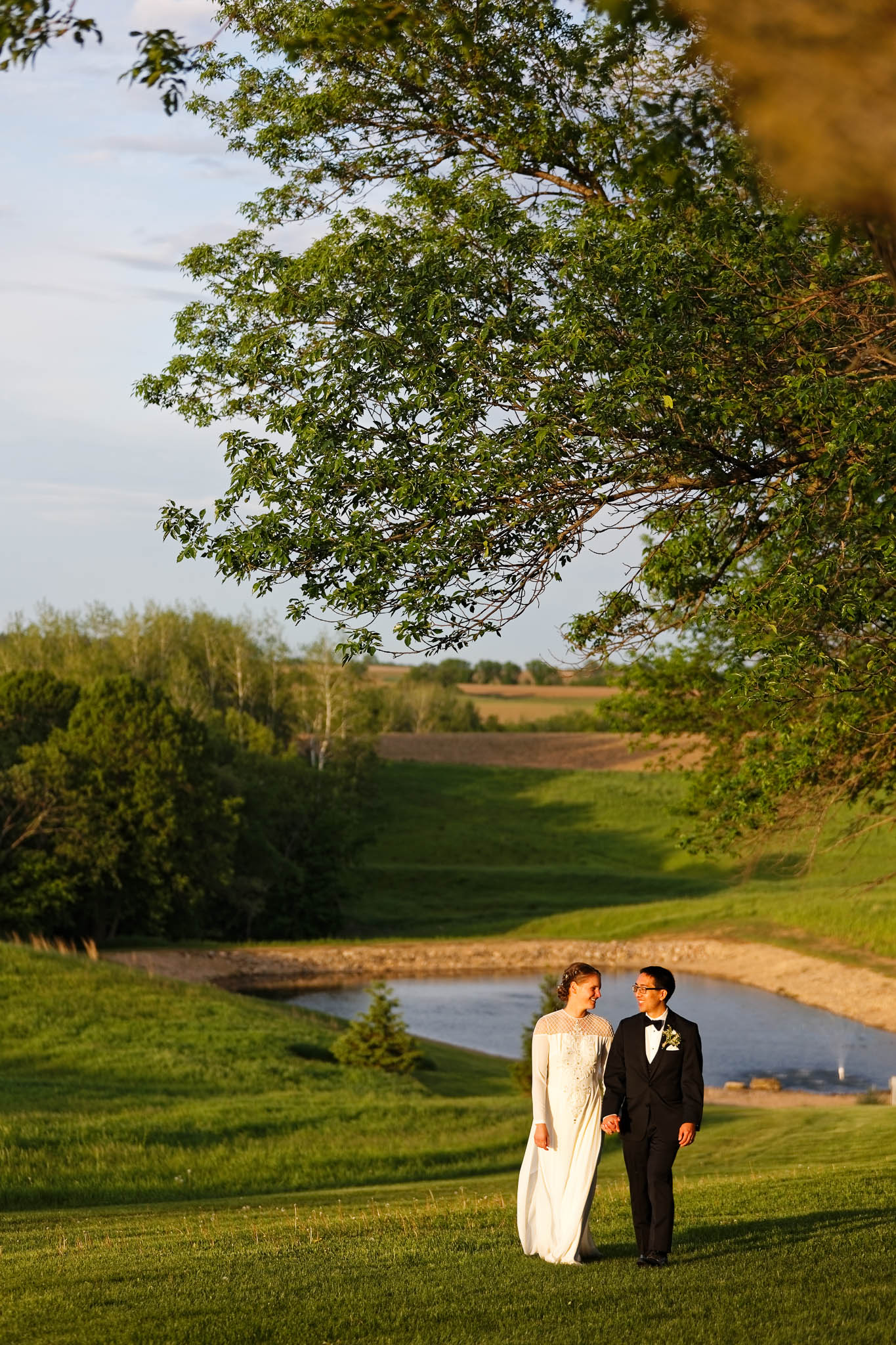 sunset bride and groom portrait with landscape including the pond