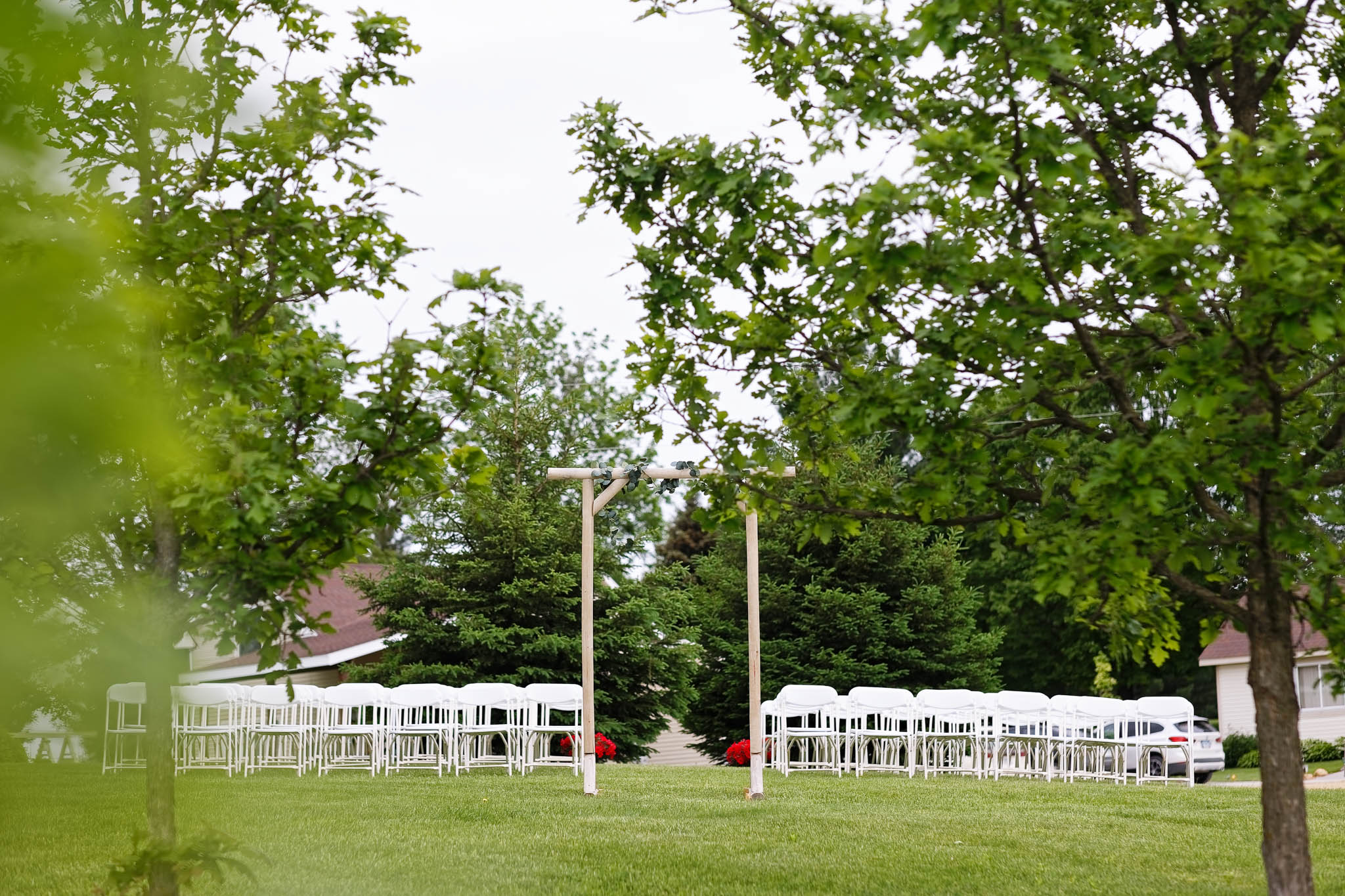 top lawn ceremony space with arch chair and oak tree