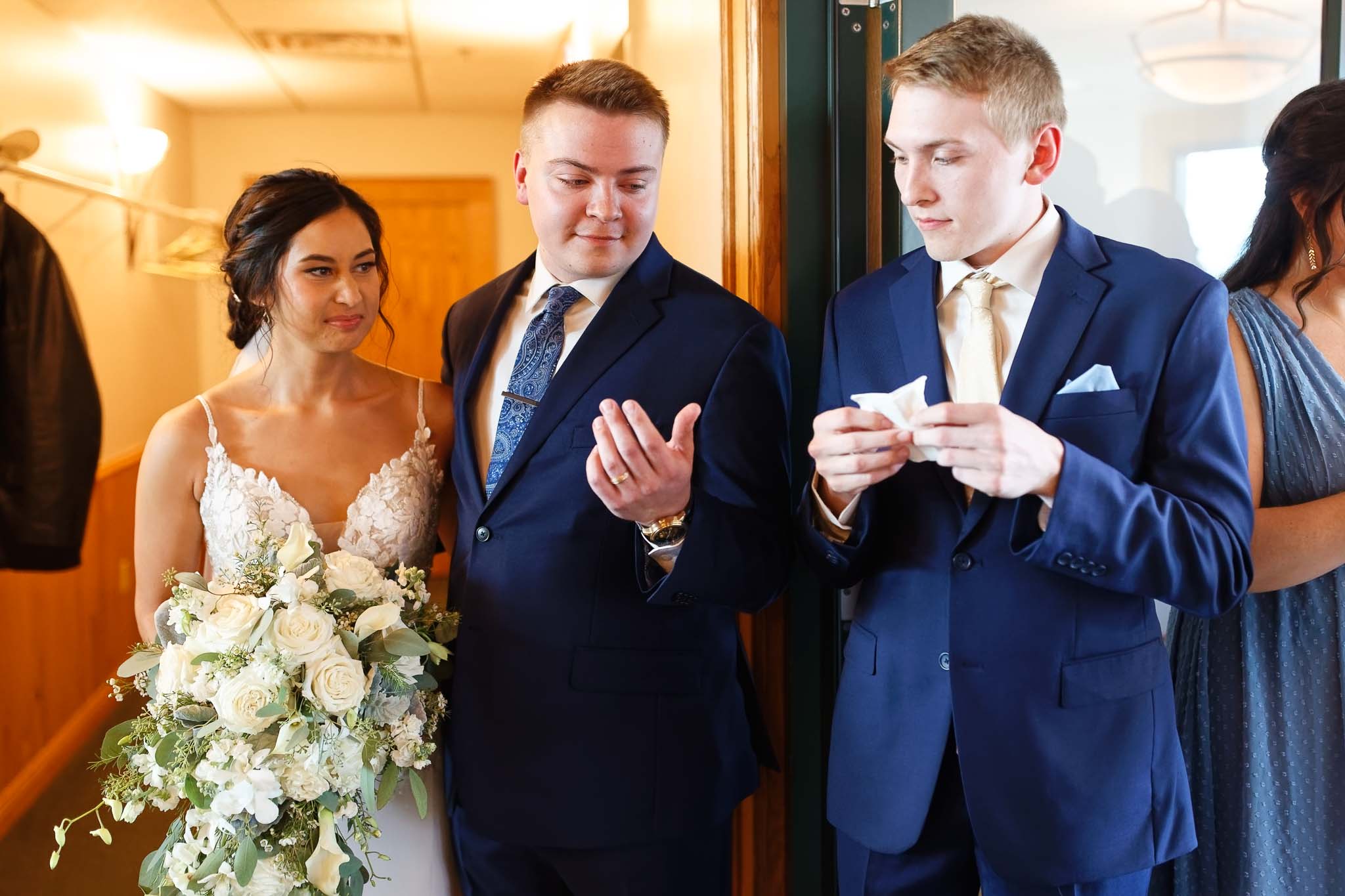 borther giving tissue to bride and groom