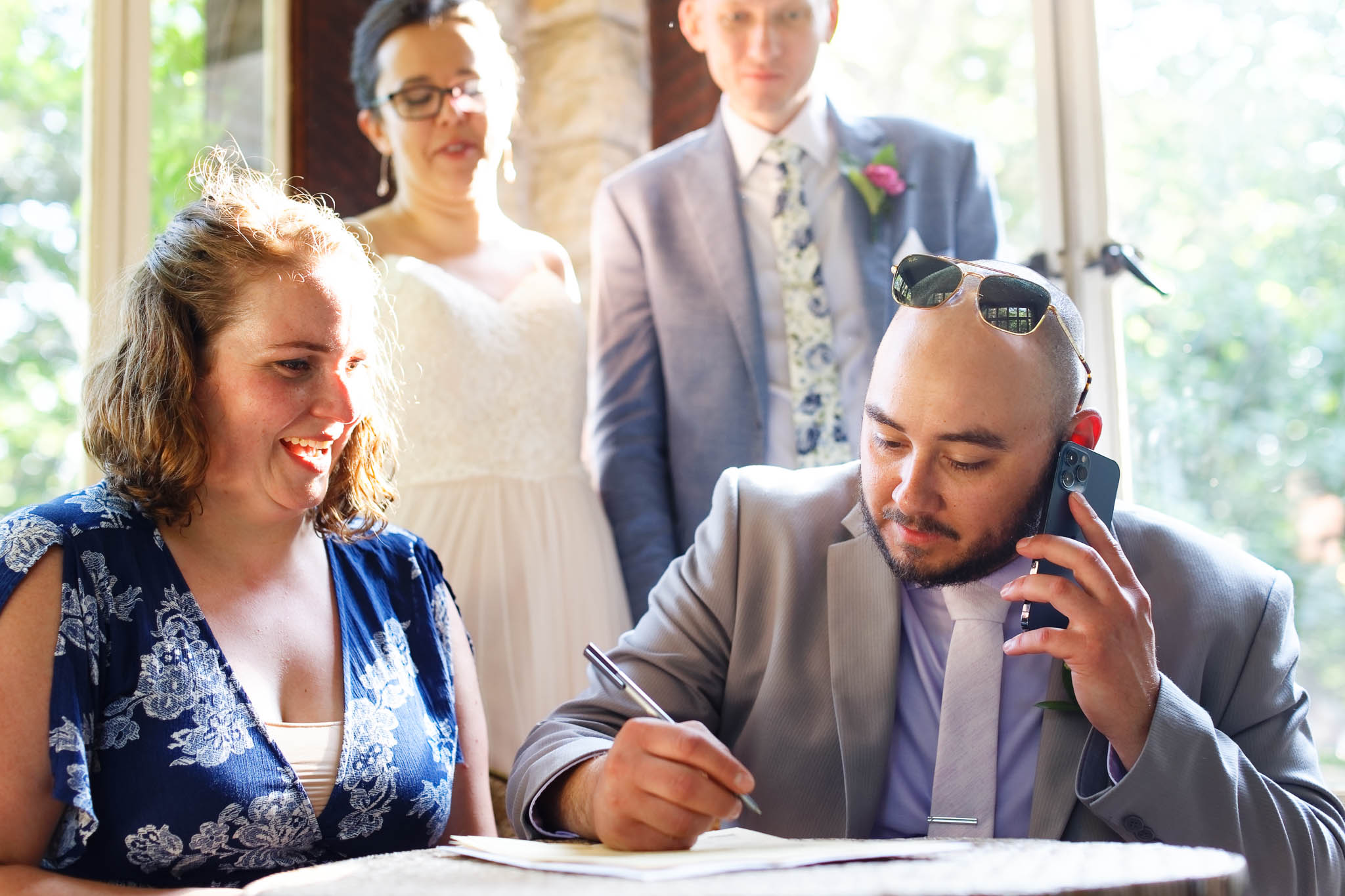 bestmen answering photos during mariage certificate signatures