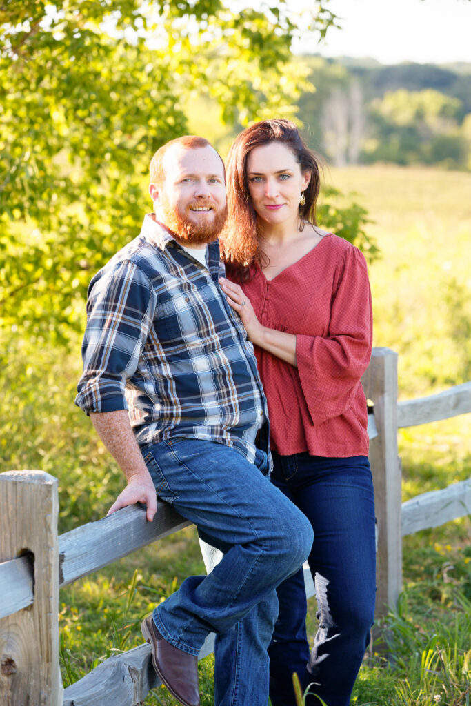 Blue and red outfit engagement session summer Willow Reservoir Park fence