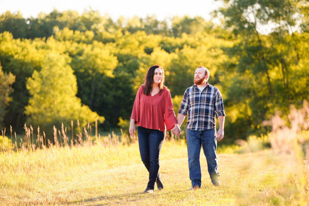 Engagement photo session with high grass and trees in Rochester