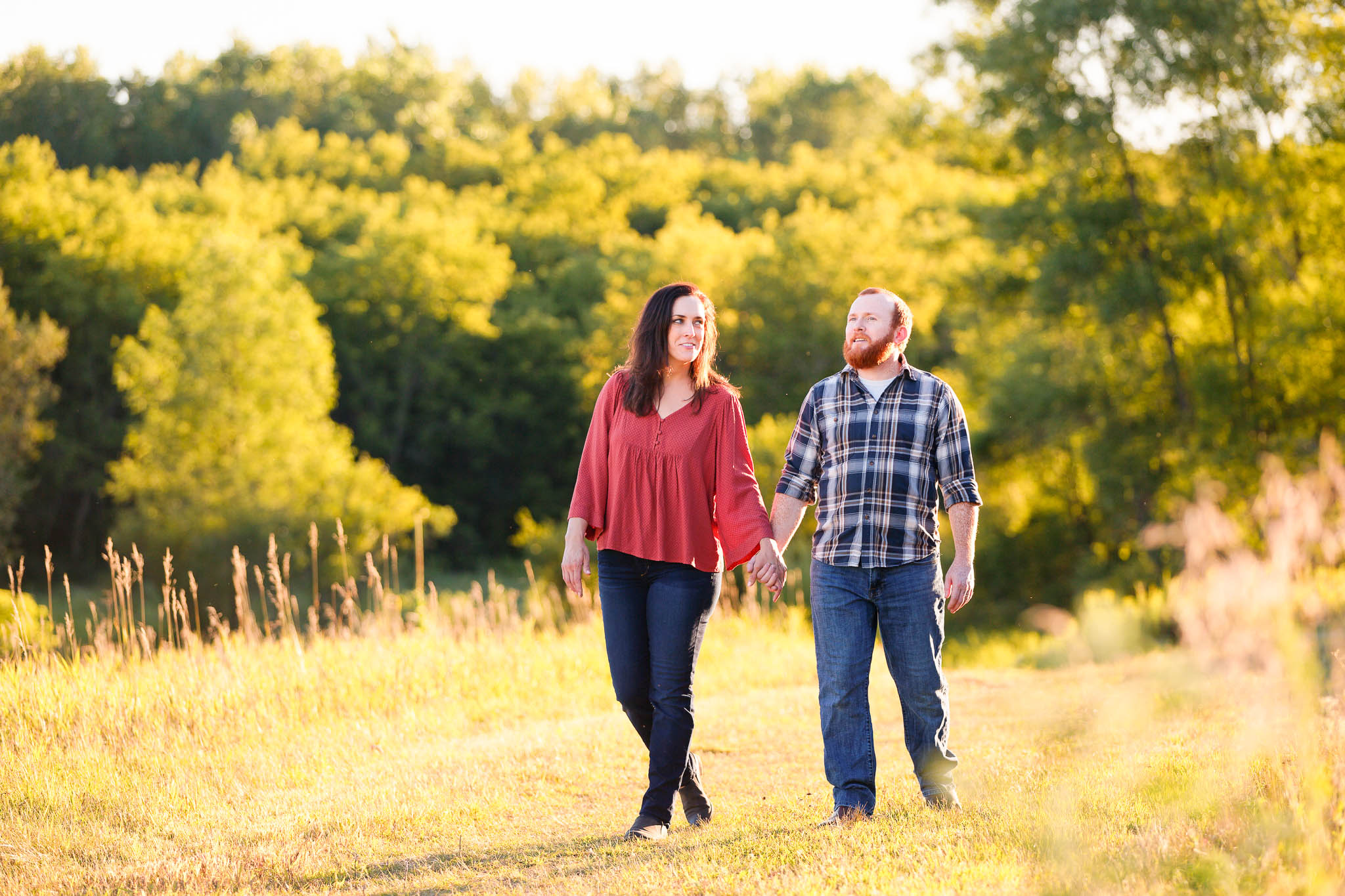 Engagement photo session with high grass and trees in Rochester