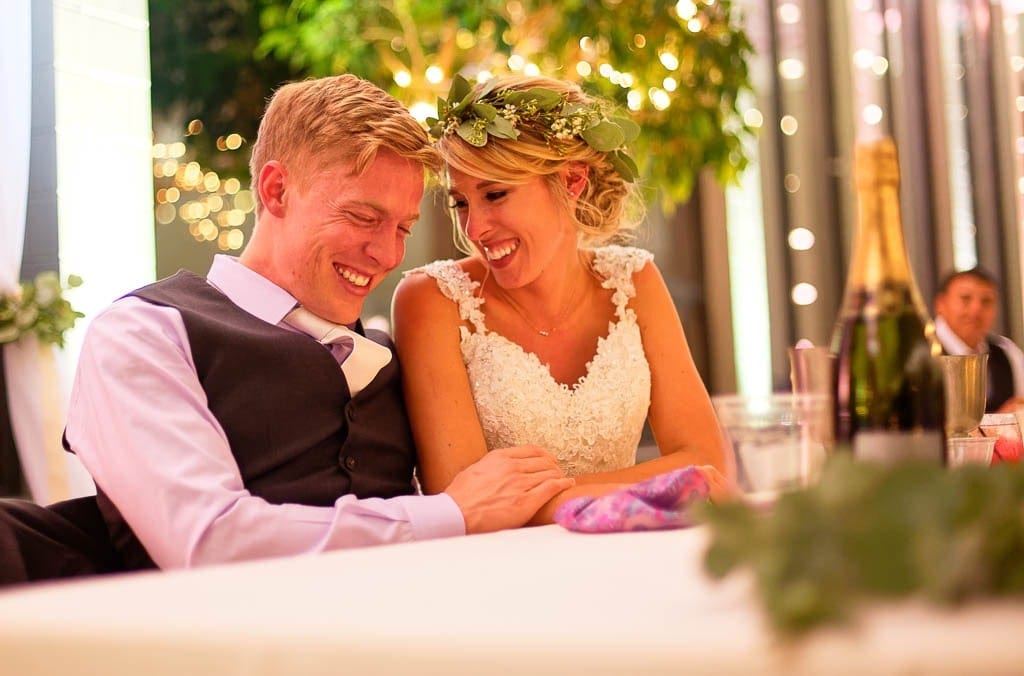 Bride and groom laughing during reception