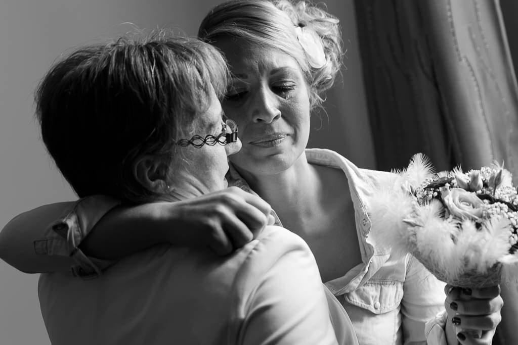 candid shot of a bride crying of joy discovering her mother