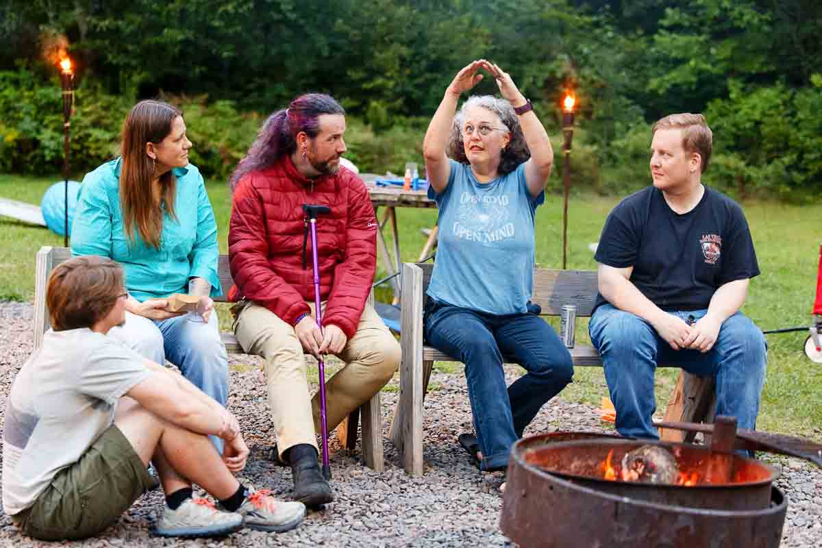 guess arround the fire pit outside at same sex wedding at st. croix state park