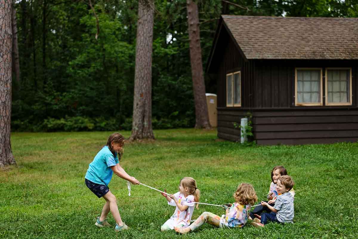 kids playing lawn games at outdoor minnesota wedding, candid afternoon activity photos at st. croix state park