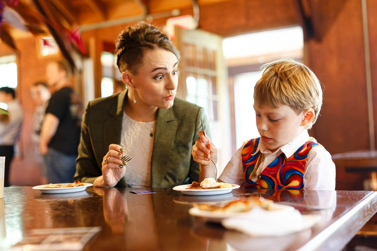 wedding brunch with crepes at st. croix state park group center dining hall, guests of all ages eating together, candid photo