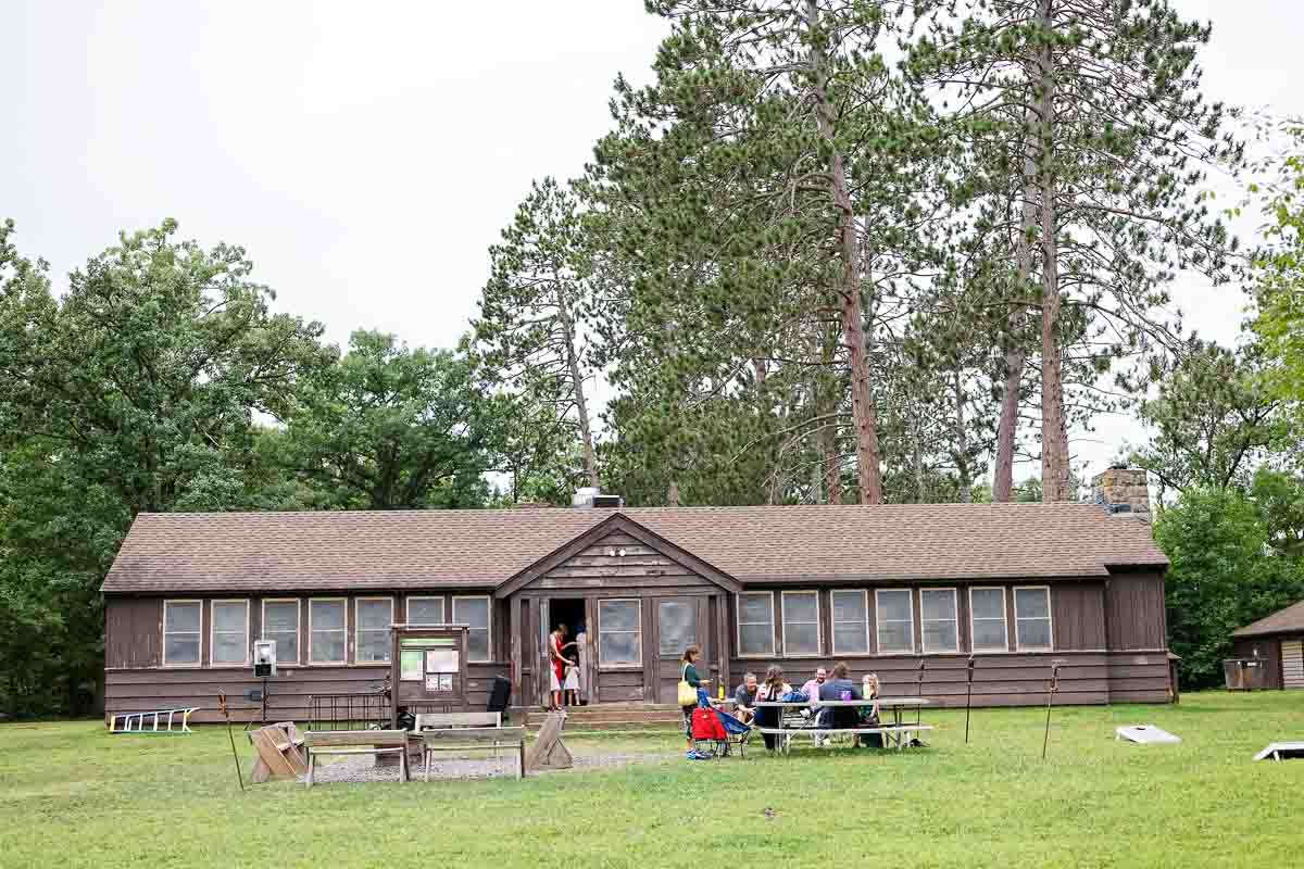 wide view of the st. croix state park group center lawn, outdoor wedding setup with guests gathered in the summer sunshine