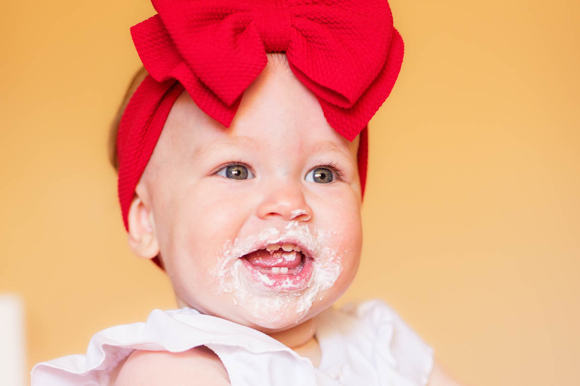 kid face covered with cake topping