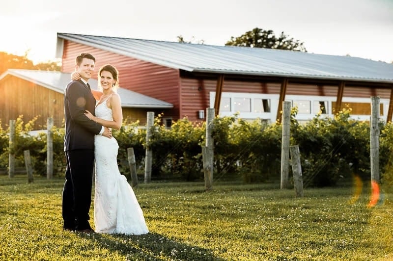 bride and groom in front Four Daughters Winery Sunset time