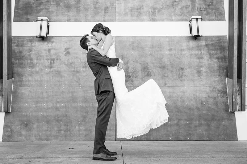 four daughters bride and groom kisssing black and white