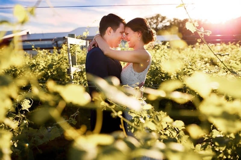 four daughters bride and groom kissing sunset