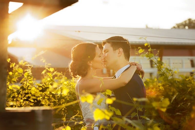 four daughters bride and groom kissing sunset