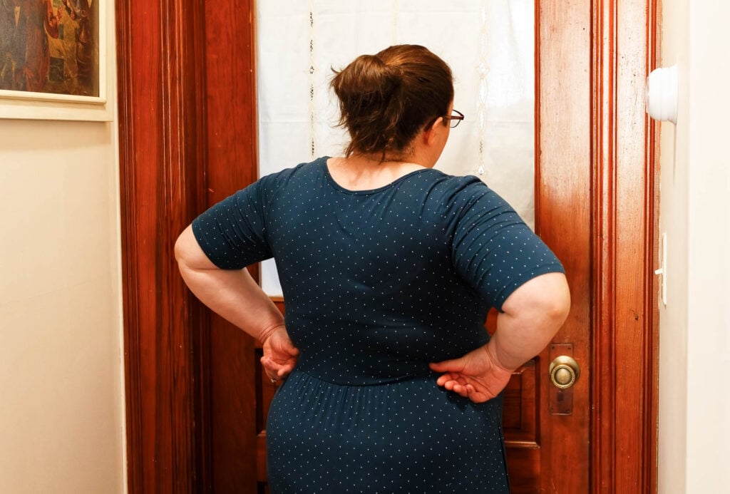 woman from back in front of a door where the bride get ready