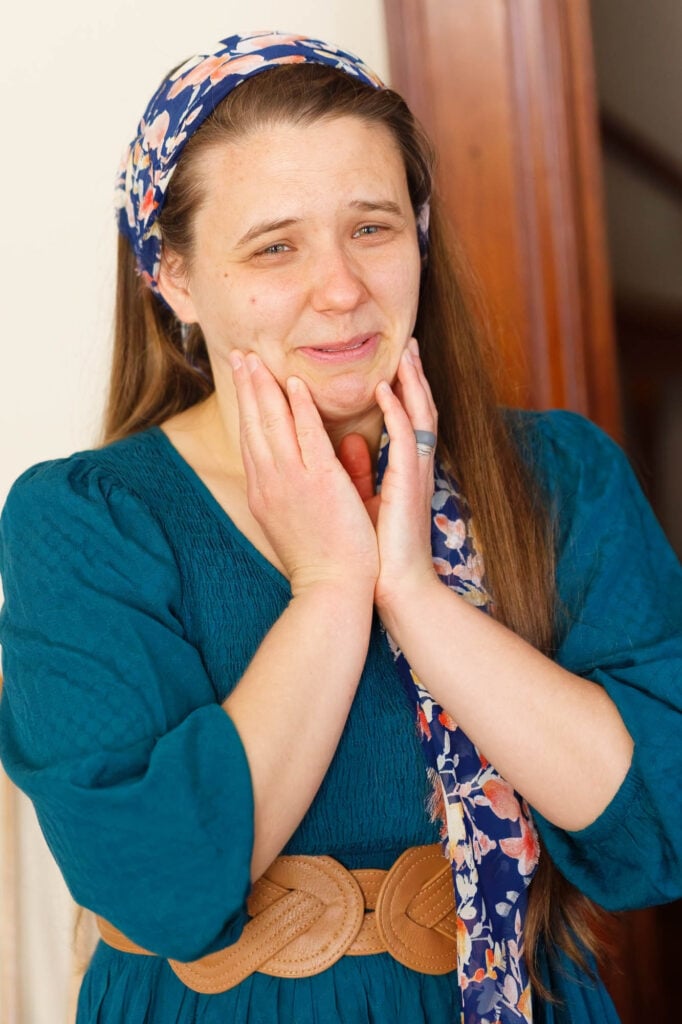 emotional friend during bride prepration holding her face