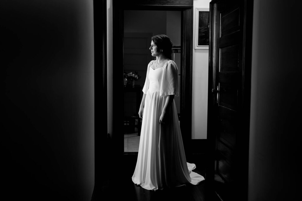 black and white photos of the bride dressed inside old home