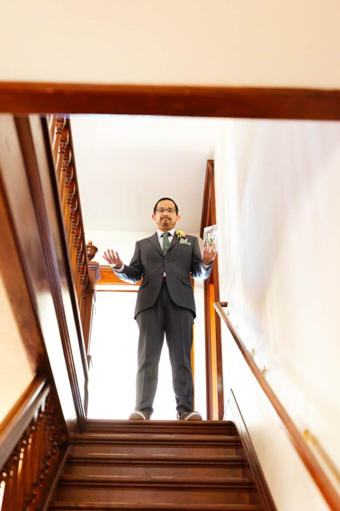 The groom at the top of the stairs