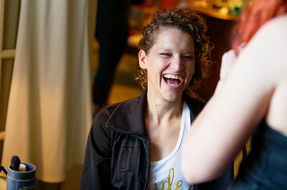 candid shot of bride laughting during getting ready