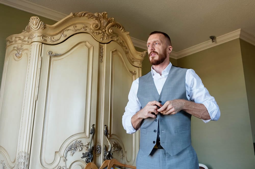 groom getting ready in the rich background of the Saint Paul Hotel