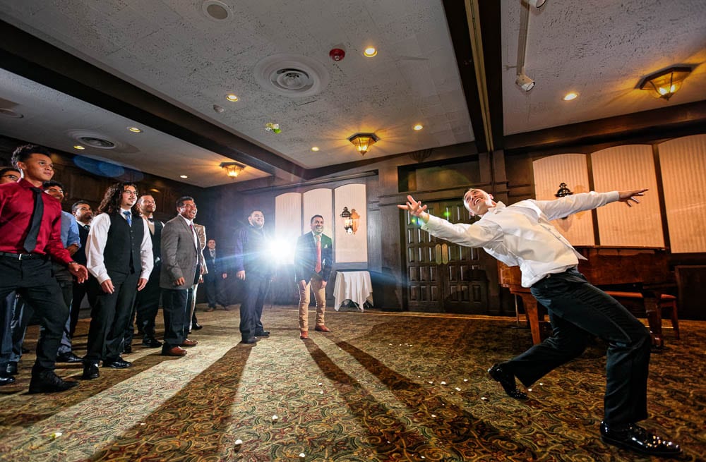 groom get married and have fun tossing boutonniere at renovated county club