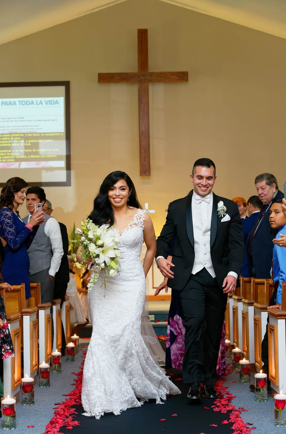 walking down the aisle surroundings by guests walking down the aisle surroundings by guests