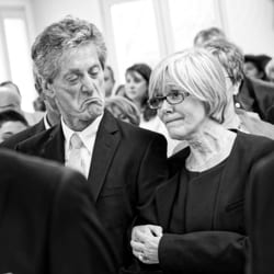 happy clients candid shot of parent's during wedding ceremony black and white image