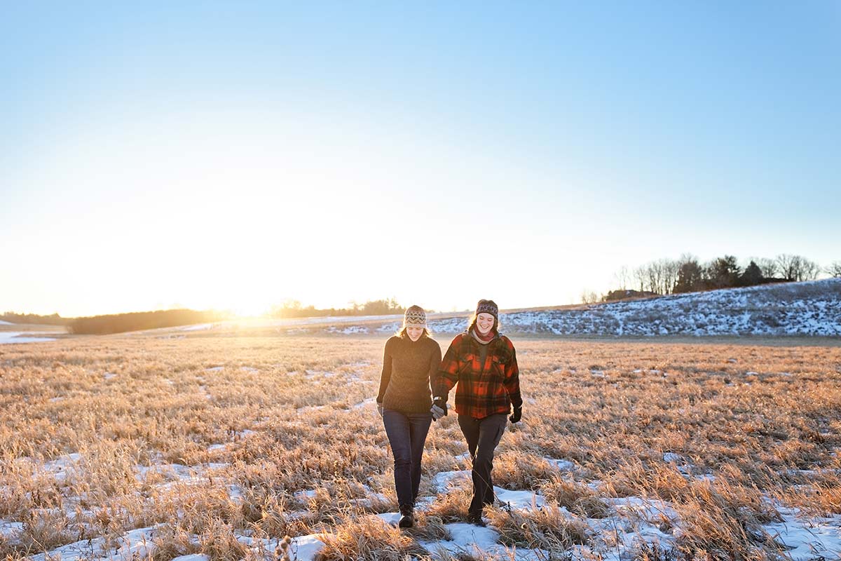 winter-engagement-session-lesbian-couple-walking-on-a-lake-