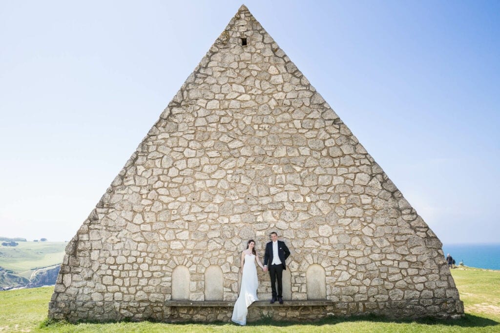 bride and groom standing in front a chapelle