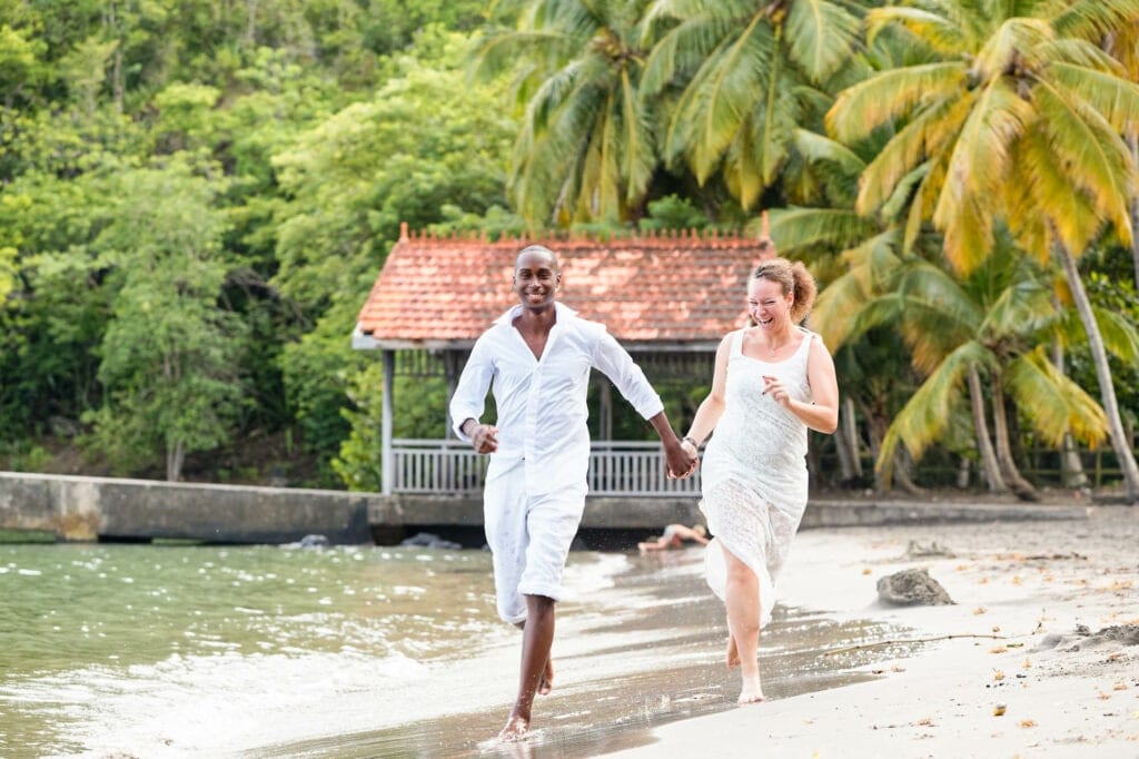 bride and groom having fun on the beach in a tropical island