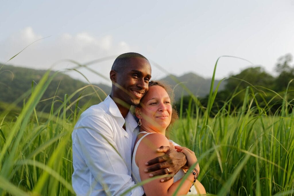 in loved couple at sunset surrounded by high vegetation