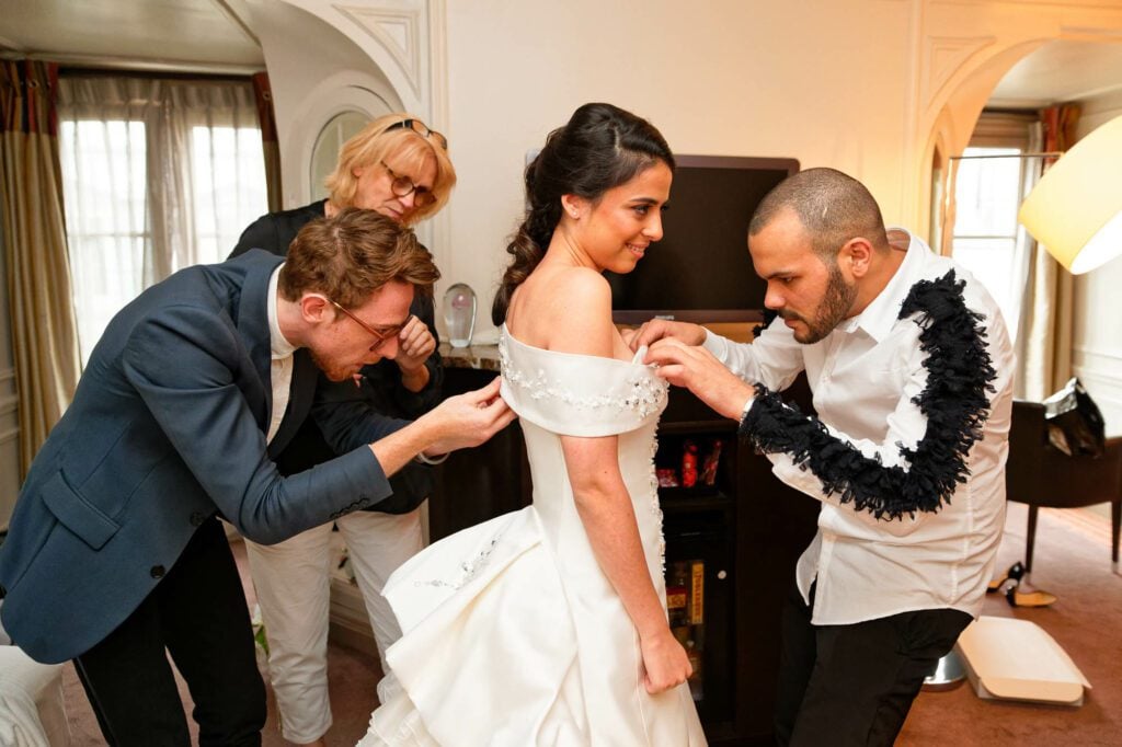 three styliste working on the bride