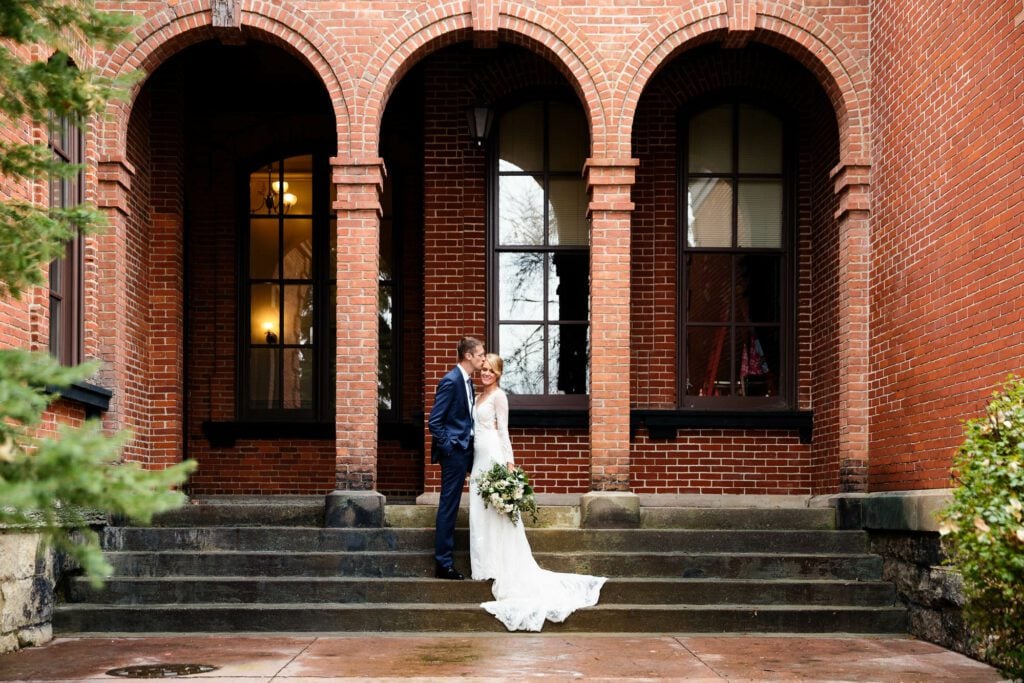 02 bride and groom standing with brick arches