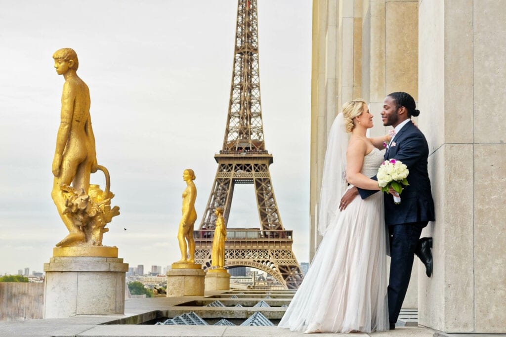 married couple in front of effeil tower france