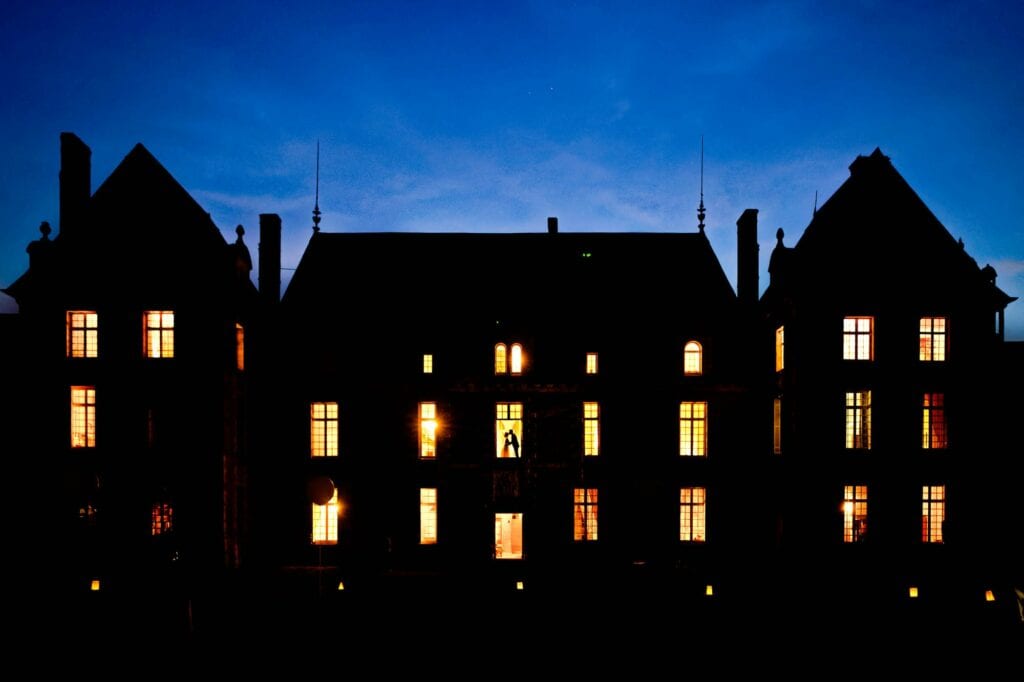 night silhouette pictures of a castle with a couple