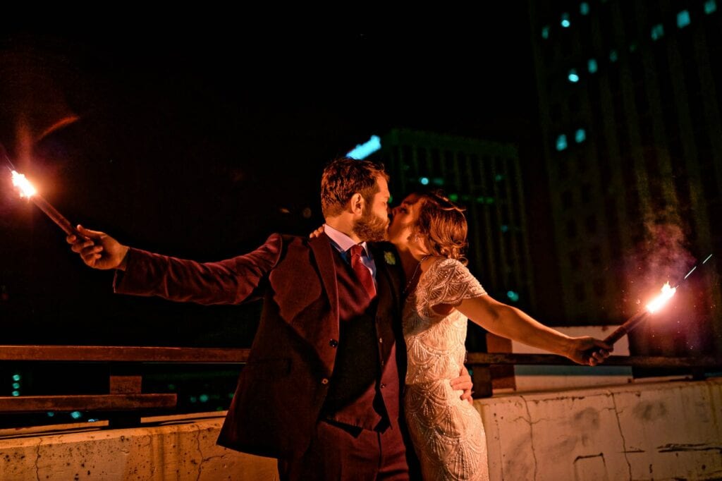 last picture with a bride and groom on a rooftop with flares