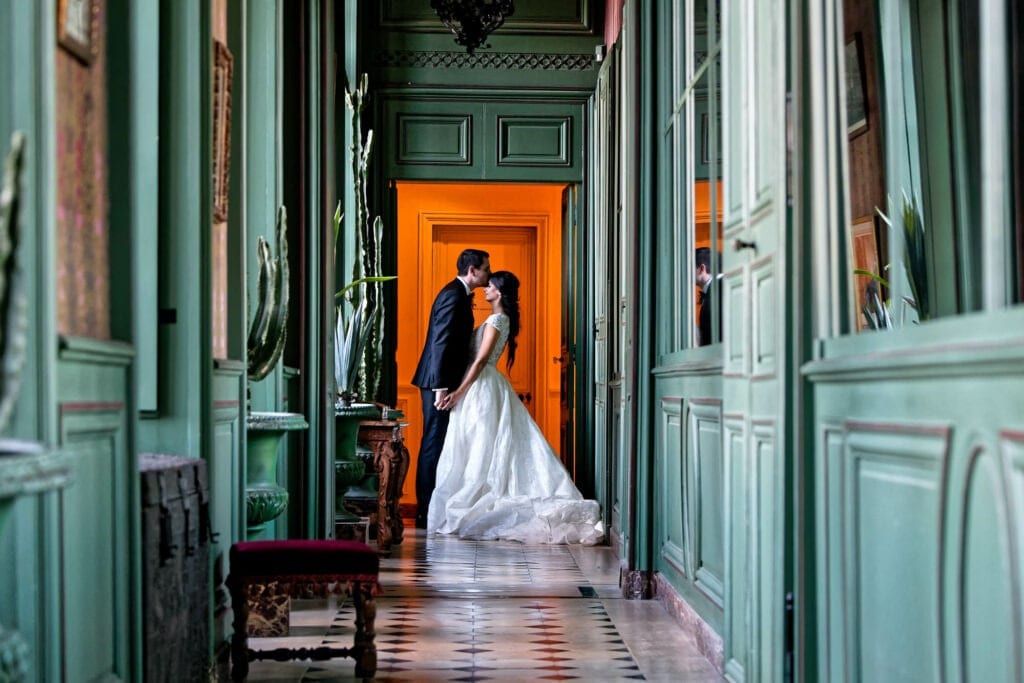 orange and green picture of a bride and groom kissing