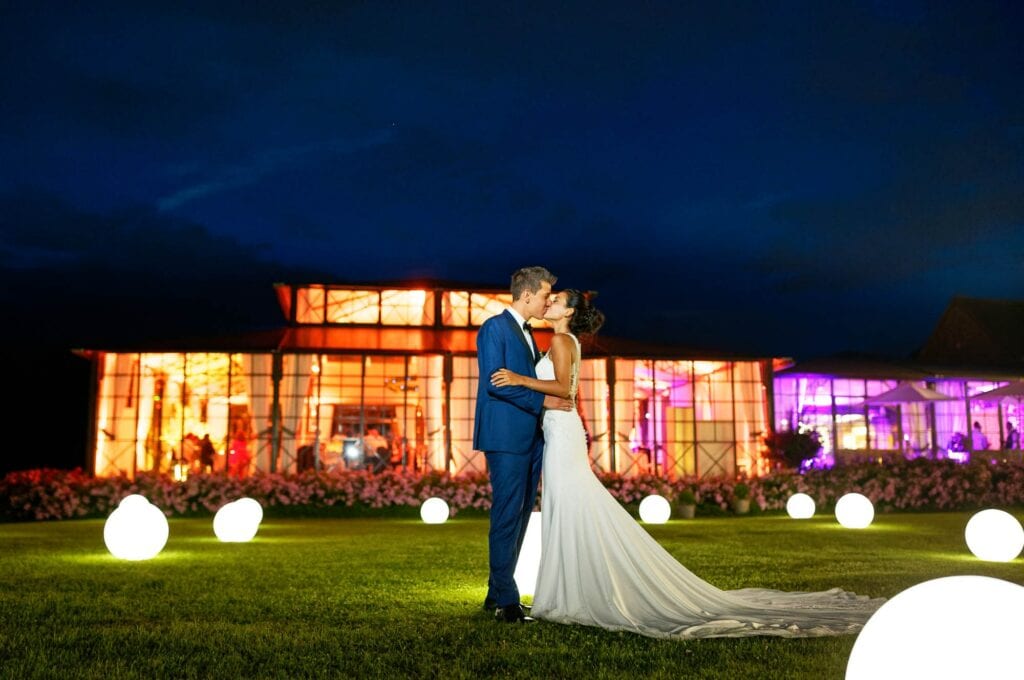 night picture newlywed couple standing on greenhouse