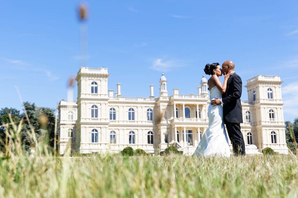 newlyweds hugging in front of a french castle