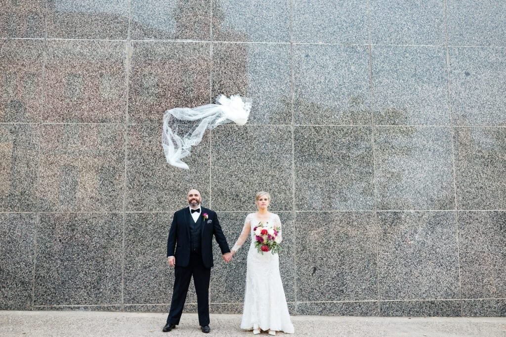 bride and groom with brirdal veil flying