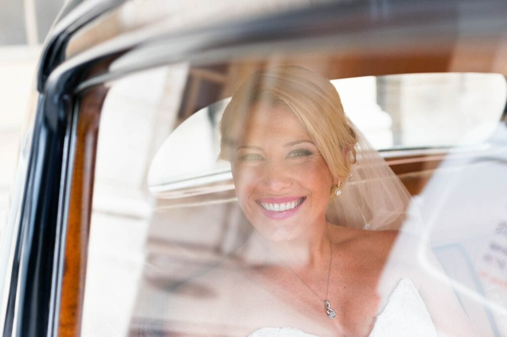 happy bride through roll royce window