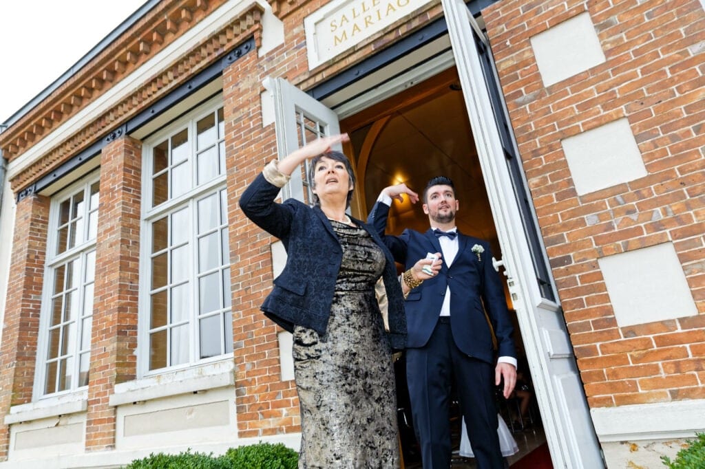 groom and his mother inviting people to enter the city hall