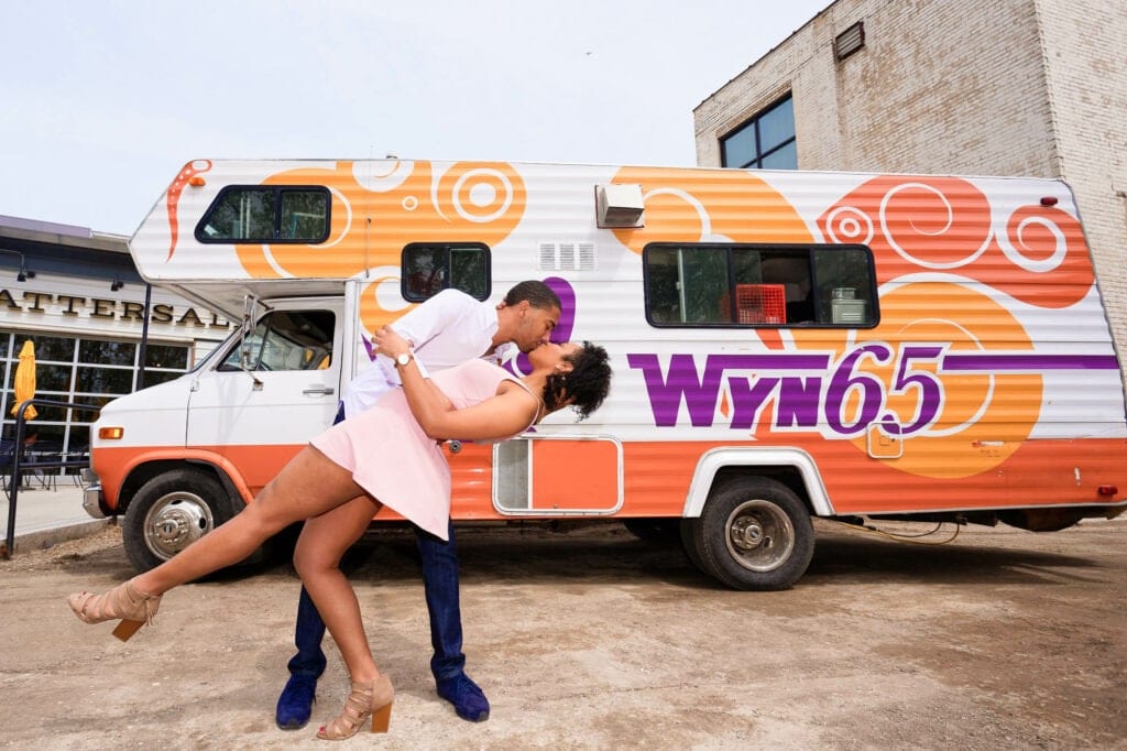 photograph of engaged couple in front of food truck having fun