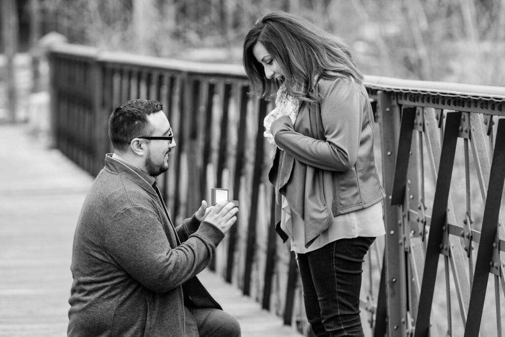 surpise proposal on bridge black on white picture