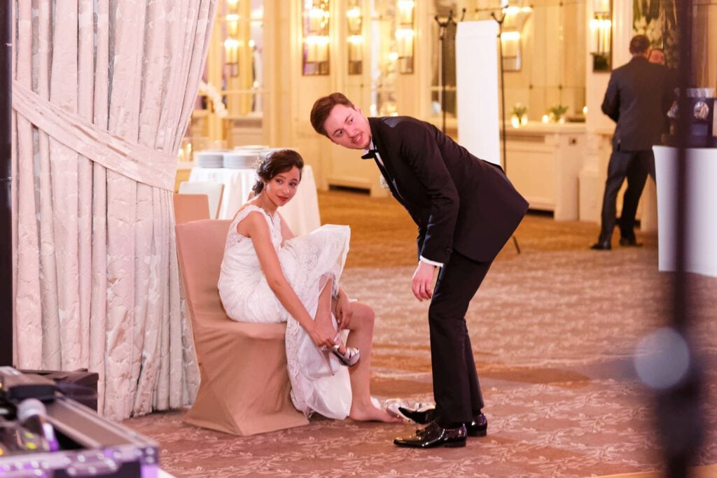 bride changing her shoes before the first dance