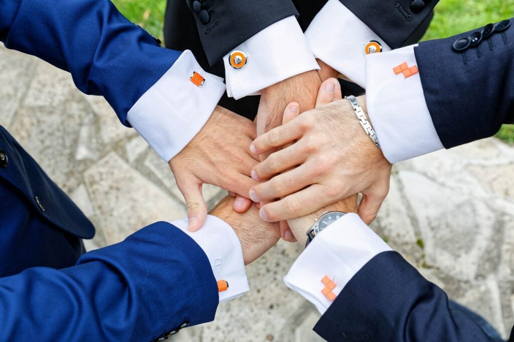 best friends sharing orange cufflinks