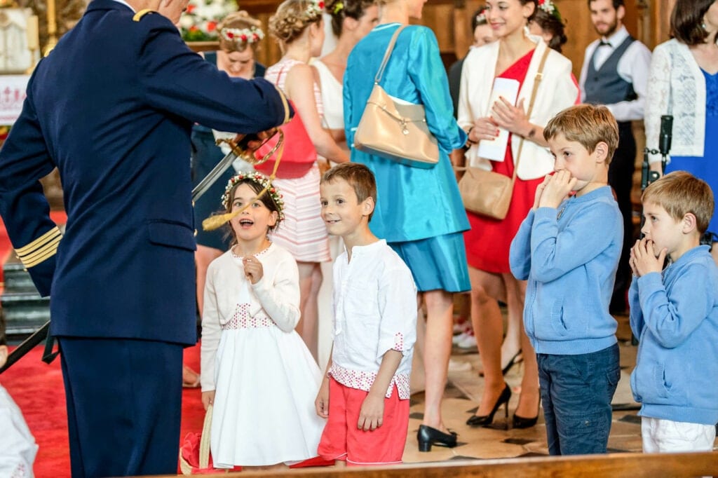 kids staring at military officer with his sword