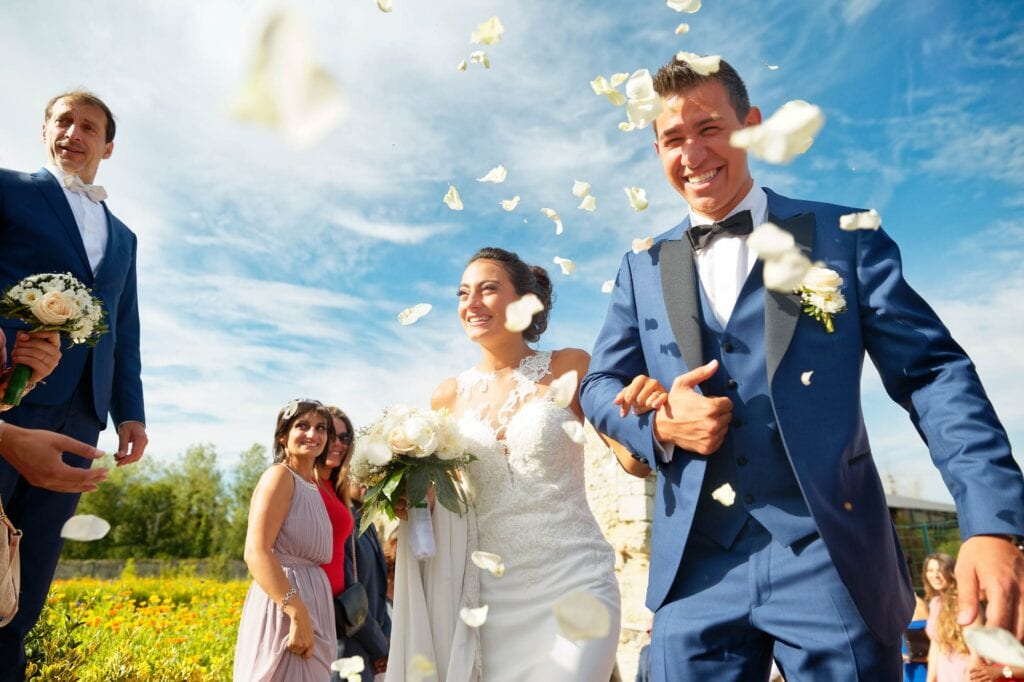 bride and couple after ceremony receiving petals