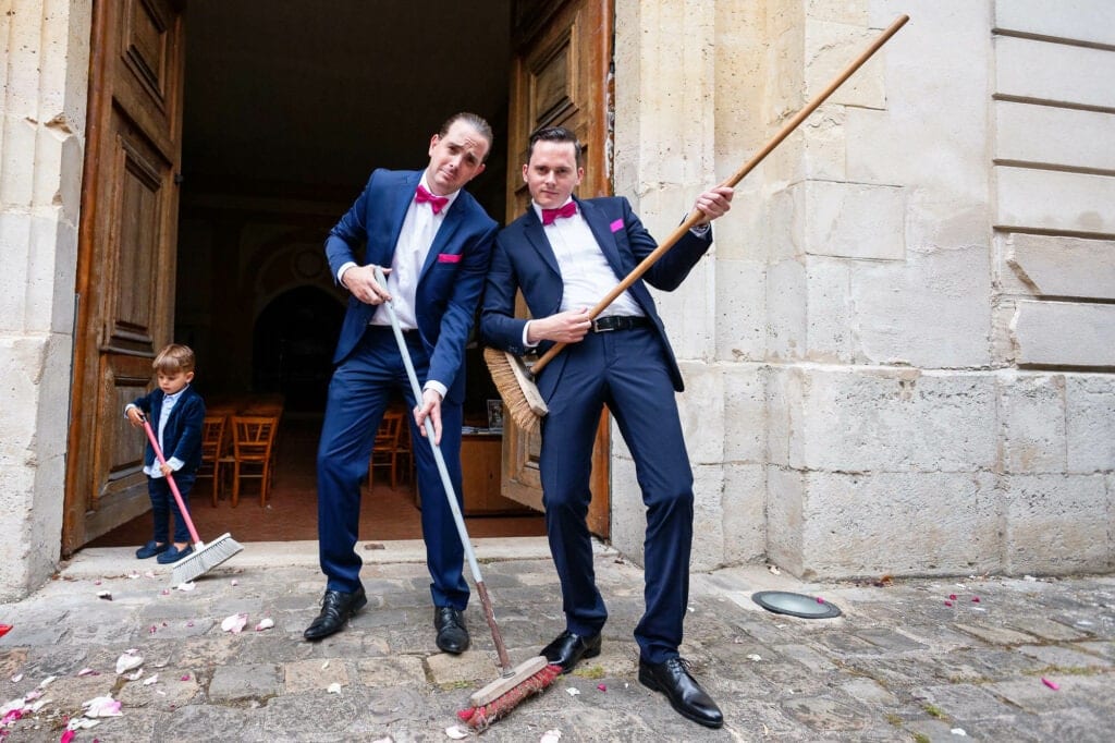 groomsmen having fun cleaning petals