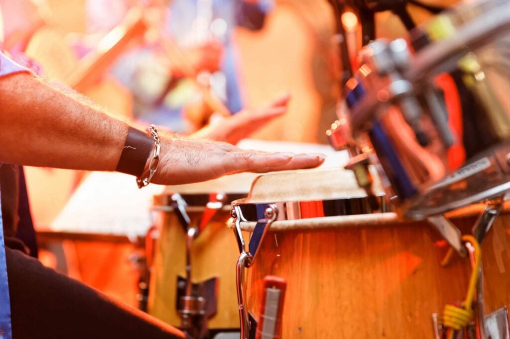 latino musician close up on hands playing drum